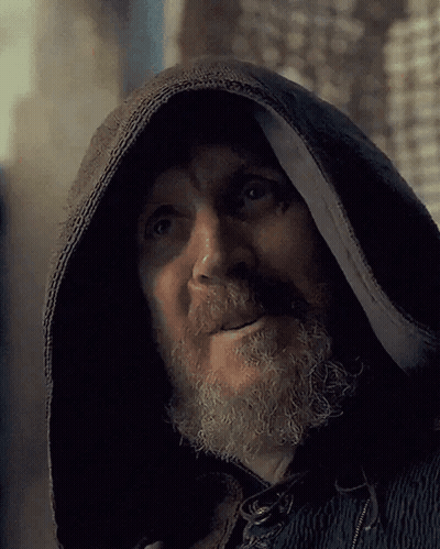 A Man With A Beard Wearing A Black Hooded Jacket GIF
