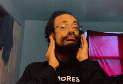 A Man With A Beard Wearing A Black Hoodie That Says Ores GIF
