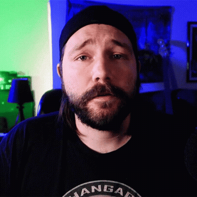 A Man With A Beard Wearing A Black Shirt That Says ' Angar ' GIF