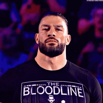 A Man With A Beard Wearing A Black Shirt That Says The Bloodline GIF