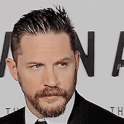 A Man With A Beard Wearing A Black Suit And Tie GIF