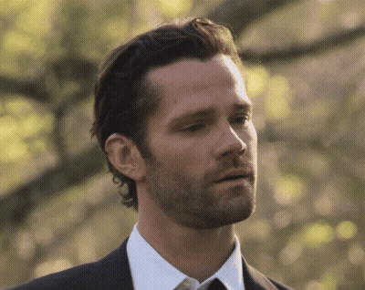 A Man With A Beard Wearing A Black Suit And White Shirt GIF