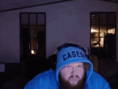 A Man With A Beard Wearing A Blue Hoodie That Says Caseon GIF