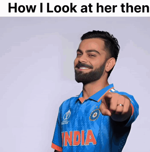 A Man With A Beard Wearing A Blue India Shirt Points At The Camera GIF