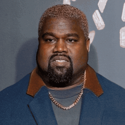 A Man With A Beard Wearing A Blue Jacket And A Gold Chain GIF