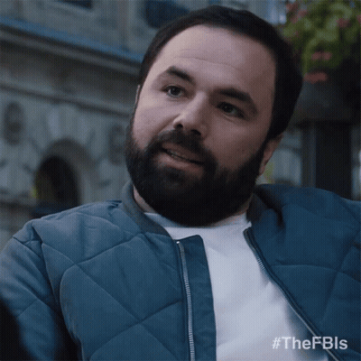 A Man With A Beard Wearing A Blue Jacket And A White Shirt GIF