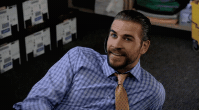 A Man With A Beard Wearing A Blue Shirt And Tie GIF