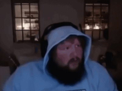 A Man With A Beard Wearing A Blue Shirt That Says Memphis On It GIF