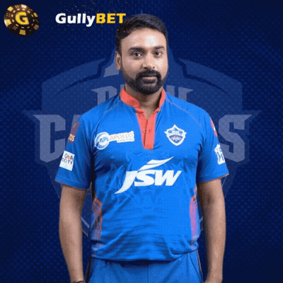 A Man With A Beard Wearing A Blue Shirt With Jsw On It GIF