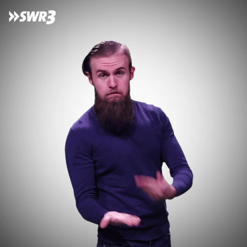 A Man With A Beard Wearing A Blue Sweater With The Letters Swr3 Behind Him GIF