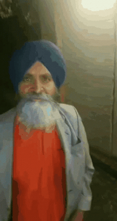 A Man With A Beard Wearing A Blue Turban And A Red Shirt GIF