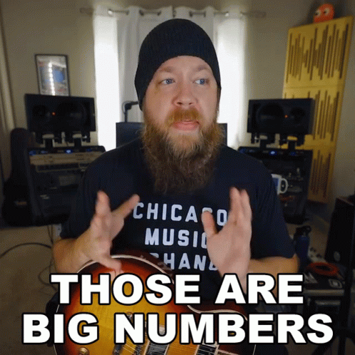 A Man With A Beard Wearing A Chicago Music Hand Shirt Says Those Are Big Numbers GIF