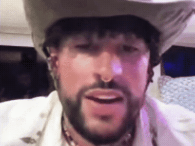 A Man With A Beard Wearing A Cowboy Hat . GIF