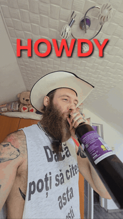 A Man With A Beard Wearing A Cowboy Hat Is Drinking From A Bottle With The Words Howdy Above Him GIF