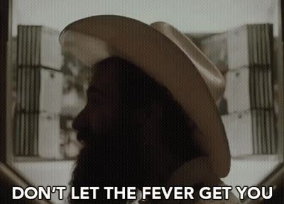 A Man With A Beard Wearing A Cowboy Hat Says " Don 'T Let The Fever Get You " GIF