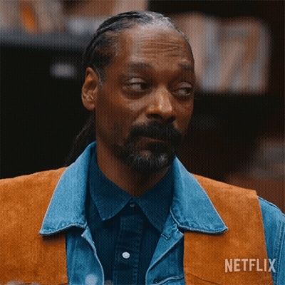 A Man With A Beard Wearing A Denim Vest And A Netflix Logo On His Chest GIF