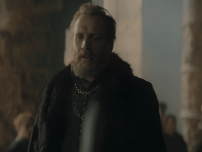 A Man With A Beard Wearing A Fur Coat And A Necklace GIF