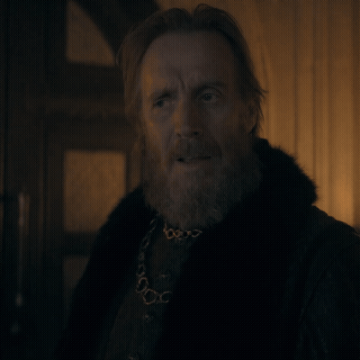 A Man With A Beard Wearing A Fur Coat And A Necklace GIF