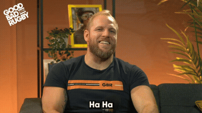 A Man With A Beard Wearing A Gbr Shirt Says Ha Ha GIF