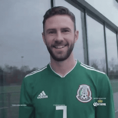 A Man With A Beard Wearing A Green Adidas Jersey GIF