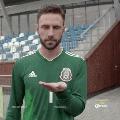 A Man With A Beard Wearing A Green Adidas Shirt GIF