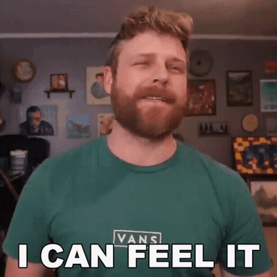 A Man With A Beard Wearing A Green Vans Shirt Says I Can Feel It GIF