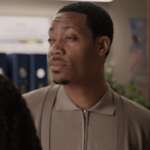 A Man With A Beard Wearing A Grey Shirt GIF