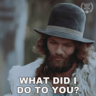 A Man With A Beard Wearing A Hat And A Fur Coat Says What Did I Do To You GIF