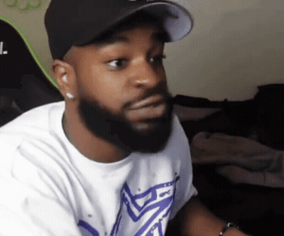 A Man With A Beard Wearing A Hat And A T-Shirt With The Letter L. On It GIF