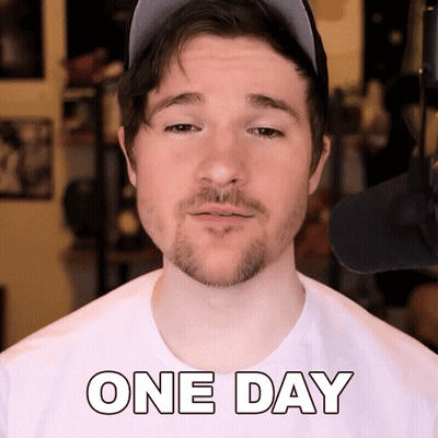 A Man With A Beard Wearing A Hat And A White Shirt That Says One Day GIF