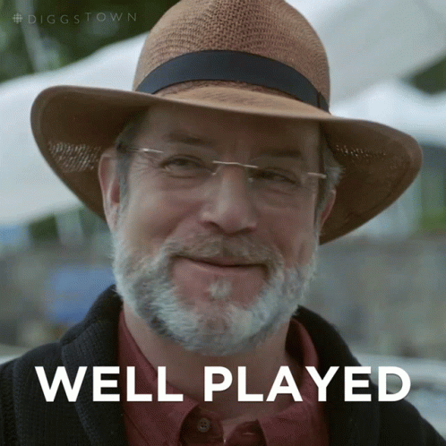 A Man With A Beard Wearing A Hat And Glasses Says " Well Played " GIF