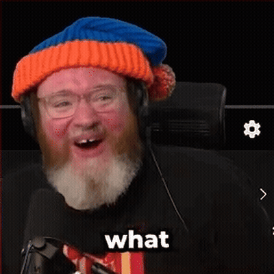 A Man With A Beard Wearing A Hat And Headphones Says The F % $ & In Front Of A Microphone GIF