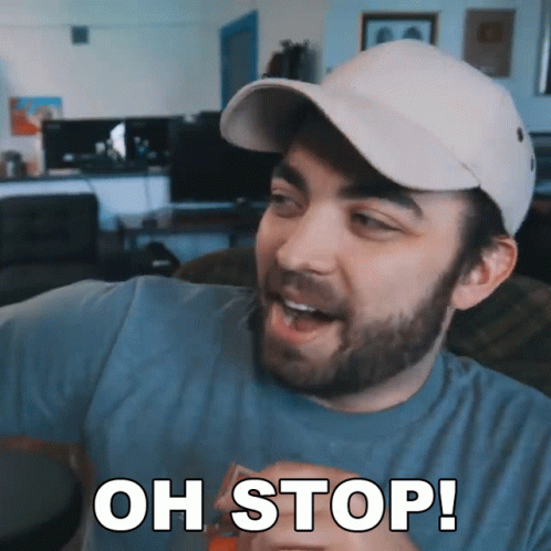 A Man With A Beard Wearing A Hat Says " Oh Stop " GIF