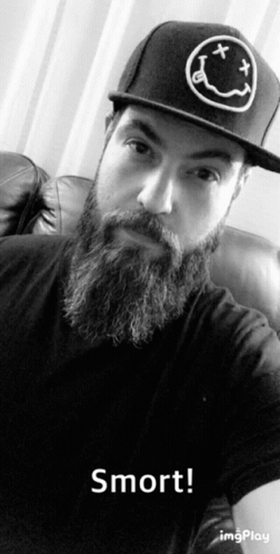 A Man With A Beard Wearing A Hat That Says Nirvana On It GIF