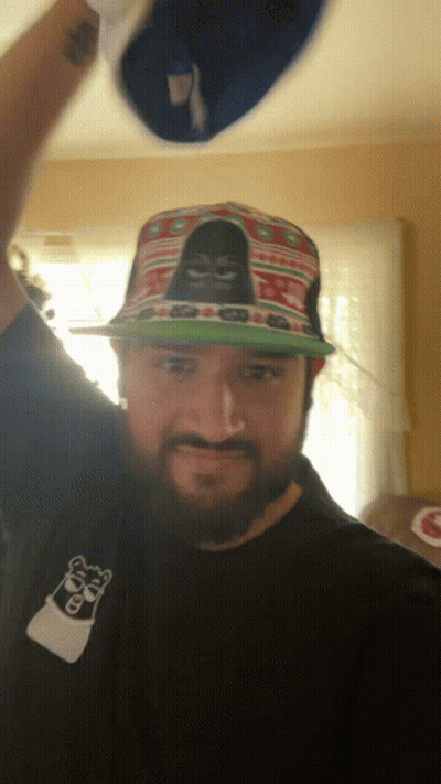 A Man With A Beard Wearing A Hat With A Gorilla On It GIF