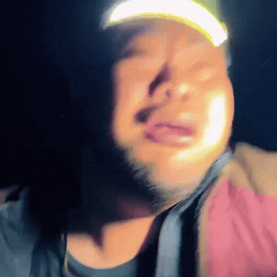 A Man With A Beard Wearing A Hat With A Yellow Light On It GIF