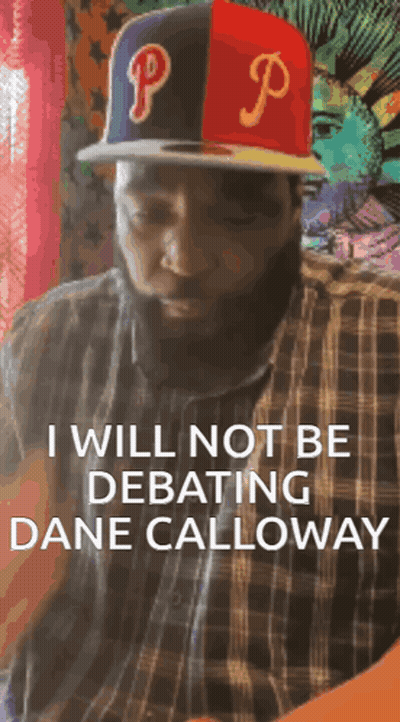 A Man With A Beard Wearing A Hat With The Letter P On It GIF
