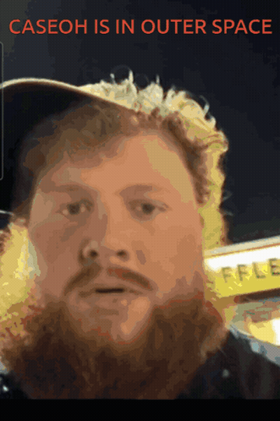 A Man With A Beard Wearing A Hat With The Words Caseoh Is In Outer Space Above Him GIF