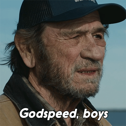 A Man With A Beard Wearing A Hat With The Words Godspeed Boys Above Him GIF