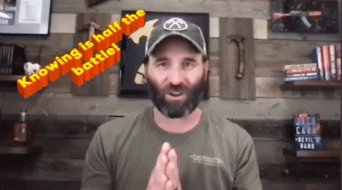 A Man With A Beard Wearing A Hat With The Words Knowing Is Half The Battle Written On It GIF