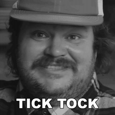 A Man With A Beard Wearing A Hat With The Words Tick Tock Above His Head GIF
