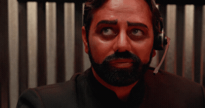 A Man With A Beard Wearing A Headset Looks At The Camera GIF