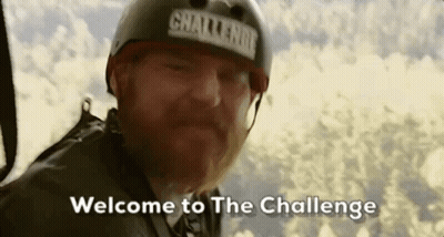 A Man With A Beard Wearing A Helmet Is Flying Through The Air And Says `` Welcome To The Challenge '' . GIF