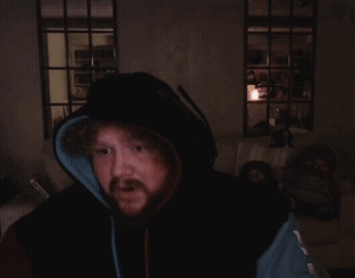 A Man With A Beard Wearing A Hoodie And Headphones Is Praying GIF