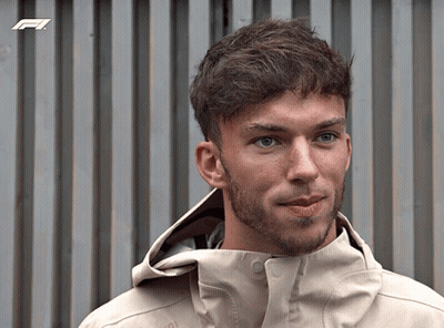 A Man With A Beard Wearing A Jacket With A F1 Logo On It GIF