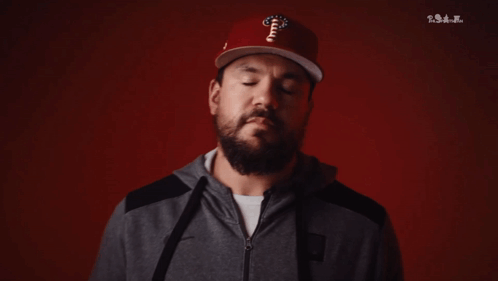 A Man With A Beard Wearing A Phillies Hat And A Hoodie GIF