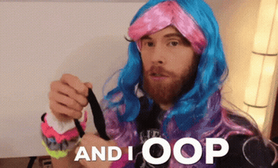 A Man With A Beard Wearing A Pink And Blue Wig With The Words And I Oop Below Him GIF