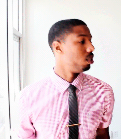 A Man With A Beard Wearing A Pink Shirt And Black Tie GIF