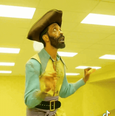 A Man With A Beard Wearing A Pirate Hat And Vest GIF