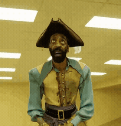 A Man With A Beard Wearing A Pirate Outfit GIF